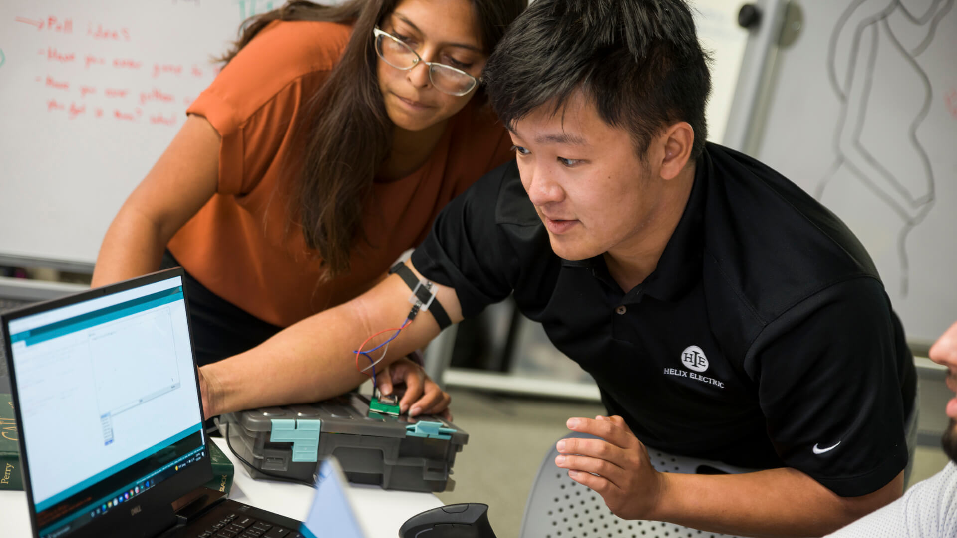 Students working on an attachable sensor that uses electromyography to better inform users of their muscle activation